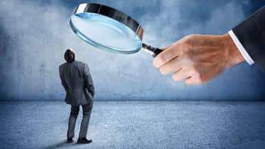 person under magnifying glass fbde