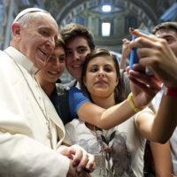 Pope Francis poses with youths during meeting with young people in St. Peter’s Basilica at Vatican